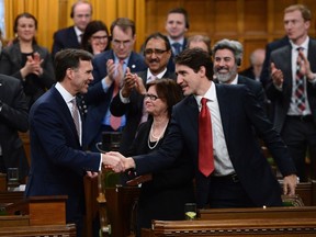 Prime Minister Justin Trudeau shakes hands with Minister of Finance Bill Morneau after he delivered the federal budget in the House of Commons on Parliament Hill in Ottawa, Wednesday, March 22, 2017.