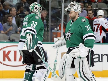 Dallas Stars' Kari Lehtonen (32) of Finland and Antti Niemi (31) of Finland tap each others leg pads as Lehtonen is replaced by Niemi in the second period of an NHL hockey game against the Ottawa Senators in Dallas, Wednesday, March 8, 2017.