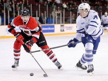 Kevin Bahl, left, and Owen Tippet battle for the puck in the second period as the Ottawa 67's take on the Mississauga Steelheads in game 4 of Ontario Hockey League playoff action at TD Place Arena.