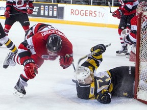 Ottawa's Sasha Chmelevski, left, stumbles as Kingston's Justin Pringle ends up in the 67's net during Saturday's game at TD Place arena.   Ashley Fraser/Postmedia