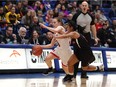 McGill's Marika Guerin drives against Carleton's Jenjen Abella during the first half of Saturday's semifinal action in Victoria.