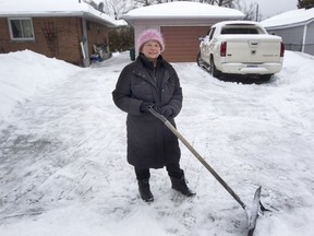 Marion Dagenais shovels the driveway of her Chatelain Avenue home.