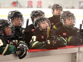 Members of the Stoney Creek Sabres Atom AA team listen to their coach against their game with the Whitby Wolves Girls Atom AA during the Bell Capital Cup at the Bell Sensplex in Ottawa, December 29, 2016.