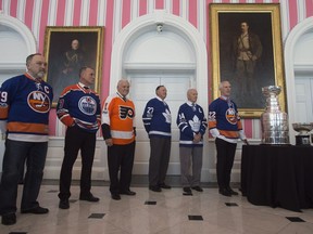 Former NHL players (left to right) Bryan Trottier, Paul Coffey, Bernie Parent, Frank Mahovlich, Dave Keon and Mike Bossy stand next to the original Stanley Cup and the Stanley Cup trophy during an event at Rideau Hall, Thursday March 16, 2017 in Ottawa.