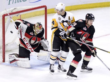 A shot by Pittsburgh Penguins' Nick Bonino (13), not shown, beats Ottawa Senators goalie Mike Condon (1) as Penguins' Chris Kunitz (14) and Senators' Mark Borowiecki (74) look on during second period NHL hockey action in Ottawa, Thursday, March 23, 2017.