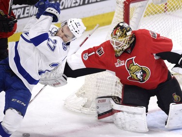Ottawa Senators' goalie Mike Condon (1) uses his blocker to keep Tampa Bay Lightning's Jonathan Drouoin (27) away from the puck during second period NHL hockey action in Ottawa, Tuesday, March 14, 2017.