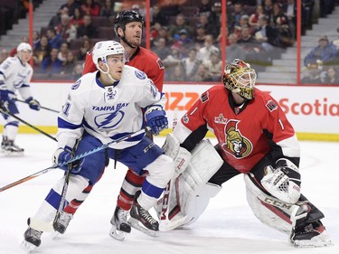 Ottawa Senators goalie Mike Condon (1), Senators' Marc Methot (3) and Tampa Bay Lightning's Brayden Point (21) watch the puck as it flies into the netting above the Ottawa net during first period NHL hockey action in Ottawa, Tuesday, March 14, 2017.