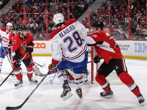 Senators defenceman Mark Borowiecki, right, pushes the Canadiens' Nathan Beaulieu as he protects the net in the first period of Saturday's game at Canadian Tire Centre.