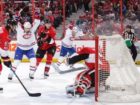 Montreal's Brendan Gallagher, middle, celebrates his third-period goal on a bad-angle shot that got through Ottawa netminder Craig Anderson.