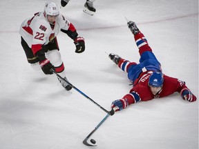 Canadiens defenceman Nathan Beaulieu tries to scoop the puck away from Senators forward a Nov. 22 game at Montreal.