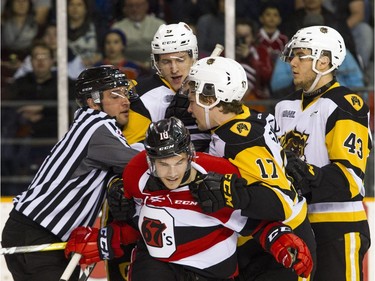 Officials pull apart Ottawa 67's #10 Zack Dorval from  Hamilton Bulldogs L-R #9 Reilly Webb, #17 Brandon Saigeon and #43 Michael Cramarossa during the first period Sunday March 19, 2017 at TD Place Arena.   Ashley Fraser/Postmedia