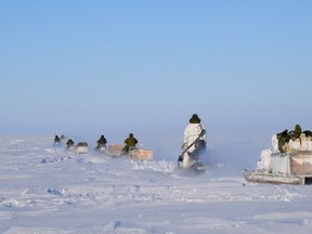Deployed members of 12e Régiment blindé du Canada and members from 1 Canadian Ranger Patrol Group leave base camp on patrol during Operation NUNALIVUT 17 in Hall Beach, Nunavut on March 1, 2017. Photo by PO2 Belinda Groves.