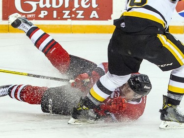 Ottawa 67's #2 Noel Hoefenmayer slides across the ice in front of Hamilton Bulldogs #18 Matthew Strome during the first period of play Sunday March 19, 2017 at TD Place Arena.   Ashley Fraser/Postmedia