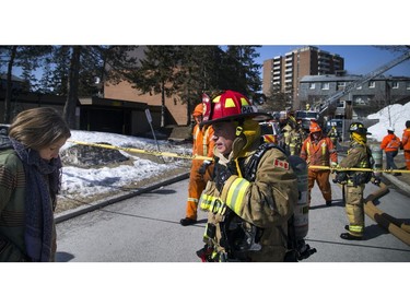 Ottawa firefighters were battling a four-alarm blaze in the Baseline-Merivale area at 34 Northview Rd., a strip of rowhouse apartments Saturday March 12, 2017. Axelle Manley who lost her home and animals speaks to a fire fighter on the scene, as they told her they were not able to save her animals. Manley was happy her and her four year old daughter escaped uninjured from the fire but was very upset over the loss of her pets.