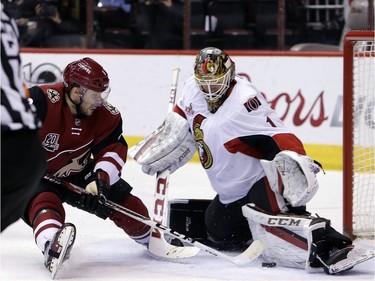 Ottawa Senators goalie Mike Condon (1) makes the save on Arizona Coyotes right wing Tobias Rieder during the second period of an NHL hockey game, Thursday, March 9, 2017, in Glendale, Ariz.