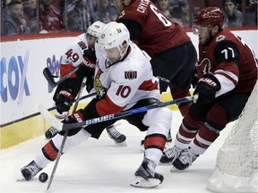 Ottawa Senators left wing Tom Pyatt (10) shields Arizona Coyotes defenseman Anthony DeAngelo (77) from the puck during the first period of an NHL hockey game, Thursday, March 9, 2017, in Glendale, Ariz.