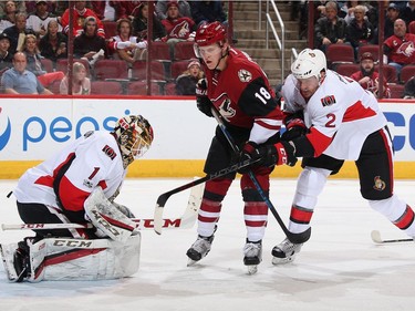 GLENDALE, AZ - MARCH 09:  Goaltender Mike Condon #1 of the Ottawa Senators makes a save on a shot as Max Domi #16 of the Arizona Coyotes skates in against Dion Phaneuf #2 during the first period of the NHL game at Gila River Arena on March 9, 2017 in Glendale, Arizona.