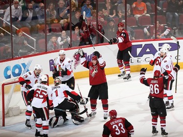 Lawson Crouse #67 (top), Shane Doan #19, Josh Jooris #86 and Alex Goligoski #33 of the Arizona Coyotes celebrate after Crouse scored a goal against goaltender Mike Condon #1 of the Ottawa Senators during the second period of the NHL game at Gila River Arena on March 9, 2017 in Glendale, Arizona.