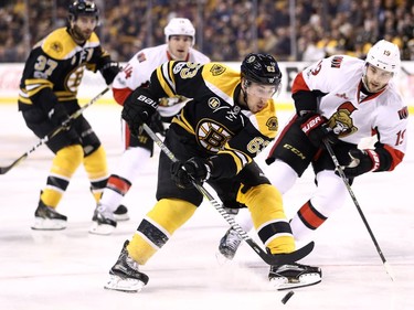 BOSTON, MA - MARCH 21: Brad Marchand #63 of the Boston Bruins skates against Derick Brassard #19 of the Ottawa Senators during the first period at TD Garden on March 21, 2017 in Boston, Massachusetts.