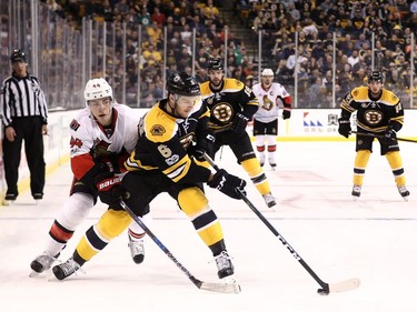 BOSTON, MA - MARCH 21: Jean-Gabriel Pageau #44 of the Ottawa Senators defends Colin Miller #6 of the Boston Bruins during the second period at TD Garden on March 21, 2017 in Boston, Massachusetts.