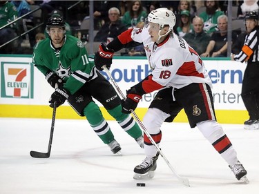 DALLAS, TX - MARCH 08:  Ryan Dzingel #18 of the Ottawa Senators skates the puck against Curtis McKenzie #11 of the Dallas Stars in the first period at American Airlines Center on March 8, 2017 in Dallas, Texas.