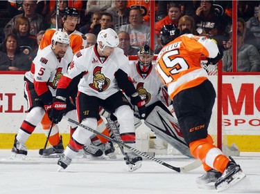 PHILADELPHIA, PA - MARCH 28: (L-R) Marc Methot #3, Alexandre Burrows #14 and Craig Anderson #41 of the Ottawa Senators defend against Michael Del Zotto #15 of the Philadelphia Flyers during the first period at the Wells Fargo Center on March 28, 2017 in Philadelphia, Pennsylvania.