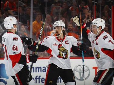 PHILADELPHIA, PA - MARCH 28: (L-R) Mark Stone #61, Erik Karlsson #65 and Kyle Turris #7 of the Ottawa Senators celebrate a first period goal by Karlsson against the Philadelphia Flyers at the Wells Fargo Center on March 28, 2017 in Philadelphia, Pennsylvania.