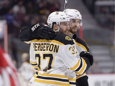 Boston Bruins' Patrice Bergeron (37) celebrates his goal against the Ottawa Senators with Adam McQuaid (54) during first period NHL hockey action in Ottawa, Monday March 6, 2017.