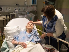 Patricia McGoldrick tends to her mother Margaret Otto, 94, waiting in an observation room to get a bed in a proper room at the Queensway Carleton Hospital recently.