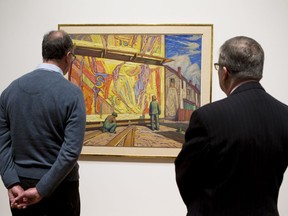 Patrons view Billboard (Jazz), 1921, by Canadian artist Lawren Harris, which is one of five paintings donated by Imperial Oil to the National Gallery of Canada collection.