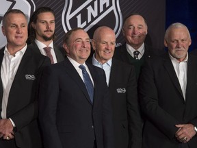 NHL Commissioner Gary Bettman, third from left, and Ottawa Senators defenceman Erik Karlsson, second from left, pose with hockey greats Paul Coffey, left to right, Dave Keon, Frank Mahovlich and Bernie Parent following the announcement of a Heritage Classic hockey game Friday March 17, 2017 in Ottawa.