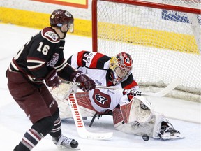 Peterborough's Steven Lorentz tries to snag the rebound of a save by Ottawa goalie Leo Lazarev a game at Peterborough last Thursday. The teams meet again at TD Place arena on Wednesday afternoon. Clifford Skarstedt/Postmedia