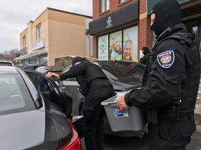 Police carry out cannabis products from Magna Terra on Tuesday afternoon.