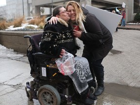 Protester Sherry Morrison gets a hug from fellow protestor Nova Coates at the Ottawa courthouse Wednesday. Sherry's daughter Cassandra was arrested at the Weeds shop on Bank Street on Jan. 31 and charged with multiple counts of drug trafficking.