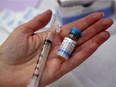 A public health nurse holds a bottle of the combined vaccine for measles, mumps and rubella. (Luke Hendry/The Intelligencer/QMI Agency)