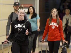 The smiles say a lot as Joanne Courtney, left, and Rachel Homan arrive in Edmonton on Monday following a triumphant trip to Beijing for the women's world curling championship. Ian Kucerak/Postmedia
