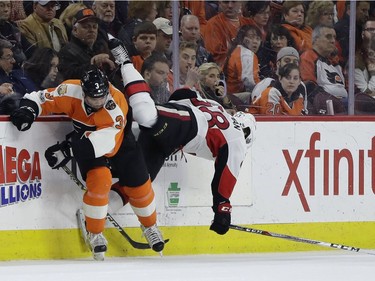 Philadelphia Flyers' Radko Gudas, left, checks Ottawa Senators' Mike Hoffman during the second period of an NHL hockey game, Tuesday, March 28, 2017, in Philadelphia.
