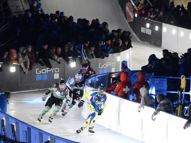 Sweden's Richard Van Wijhe leads USA's Tyler Witty as he skates in the Red Bull Crashed Ice World Championship at the Rideau Canal Locks on Saturday, March 4, 2017, in Ottawa.