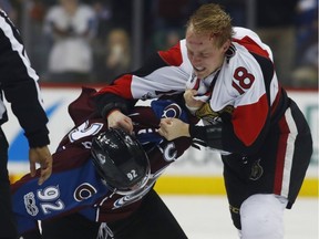 Senators winger Ryan Dzingel fights Avalanche forward Gabriel Landeskog late in the third period of Saturday night's game in Denver.