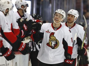 Senators winger Ryan Dzingel receives congratulations from teammate after scoring a goal in the third period of Saturday's game.