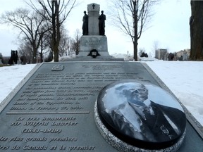 Sir Wilfrid Laurier's gravesite at Notre Dame Cemetery in Ottawa, which has seen better days. The portrait of the Canadian Prime Minister on a panel in front is badly weathered and the bronze wreath at the base of the main monument is now green.
