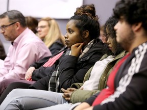 Some Rideau High School students take the front row at the meeting, awaiting the fate of their school on Tuesday night.