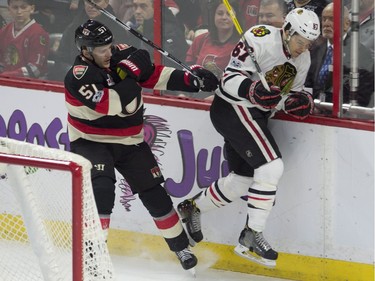 Ottawa Senators centre Tommy Wingels sends Chicago Blackhawks centre Tanner Kero into the boards during first period NHL action, in Ottawa on Thursday, March 16, 2017.