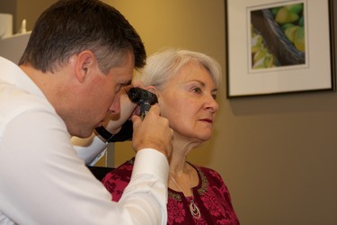 An Audiologist examines the outer ear and canal prior to testing.