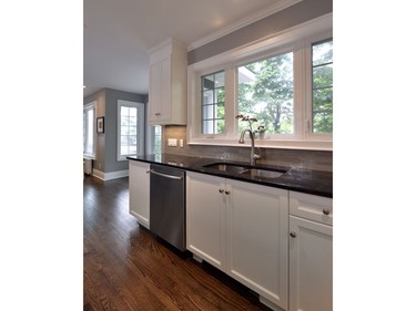 The new kitchen features custom millwork, hardwood flooring and stone countertops.