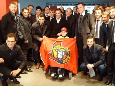 The Ottawa Senators pose with Jonathan Pitre during a visit in Minneapolis on Wednesday, March 29, 2017.  Photo by Bruce Garrioch/Postmedia