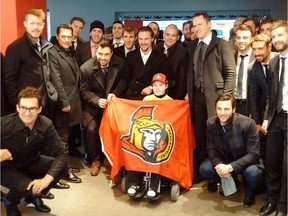 The Ottawa Senators pose with Jonathan Pitre during a trip to Minneapolis on Wednesday, March 29, 2017.