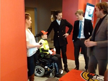The Ottawa Senators' Erik Karlsson, Kyle Turris and Bobby Ryan visit with Jonathan Pitre and his mother, Tina Boileau.