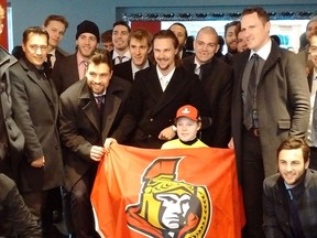 Ottawa Senators coach Guy Boucher, seen at left during this week's visit with Jonathan Pitre, said it was good for both the family and the team.