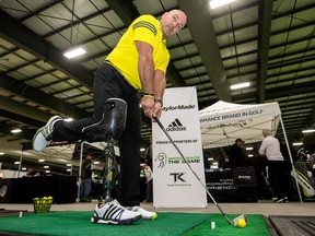 Todd Keirstead demonstrates setting with a prosthetic-leg device for a demonstration of his Bring Back the Game program aimed at getting injured or wounded veterans and civilians back into golf. Wayne Cuddington/Postmedia